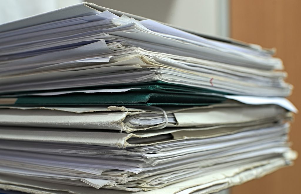 closeup of a stack of old paperwork and folders